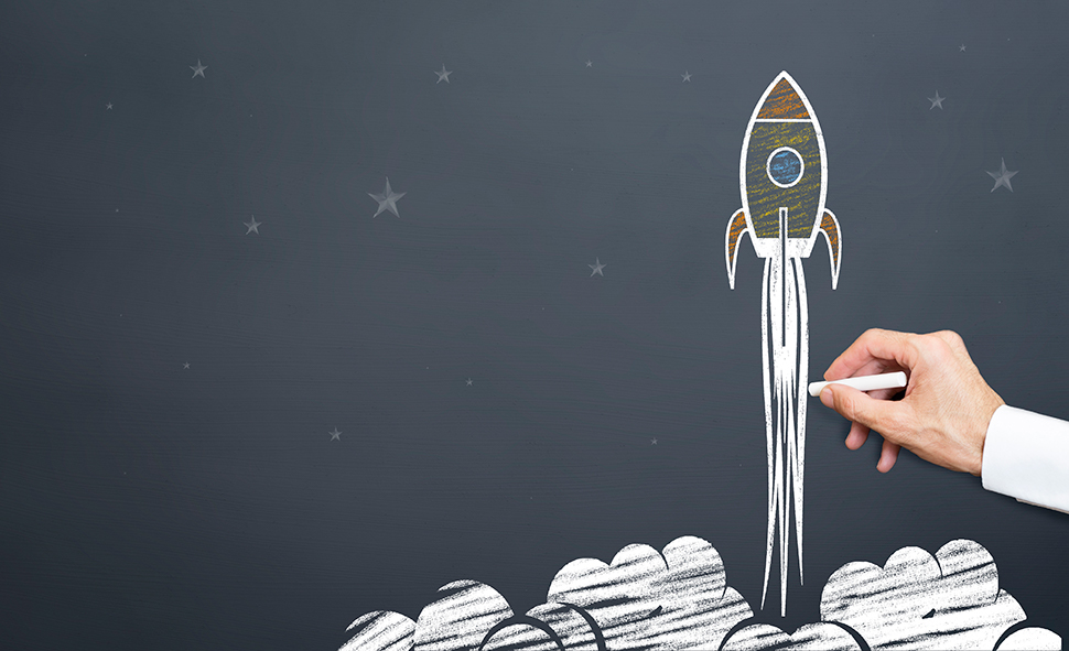 Rocket launching sketch on chalkboard representing the launch phase